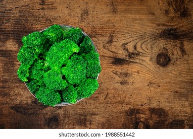 Cooked Broccoli With Copy Space. Boiled Broccoli In A Bowl, Overhead Shot On A Dark Rustic Wooden Background With A Place For Text