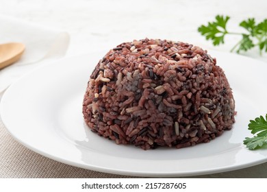 Cooked Brown Rice Or Riceberry Rice On White Plate On Wood Table