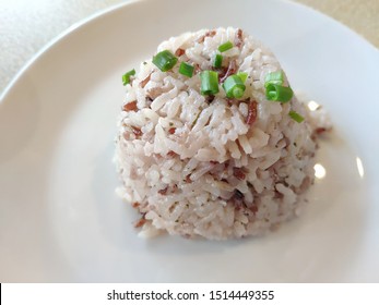 Cooked Brown Rice In White Plate.