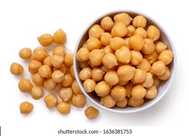 Cooked Chick Peas In A White Ceramic Bowl Isolated On White. Spilled Chick Peas. Top View.