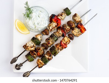 Cooked Chicken Kabobs With Veggies And Tzatziki On The Side.