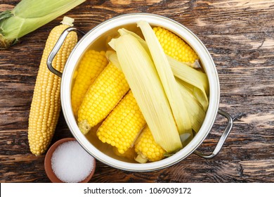 Cooked Corn Cobs In A Pot, Top View, Space For Text