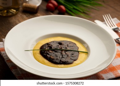 Cooked Corn Meal With Funghi Sauce On White Plate.