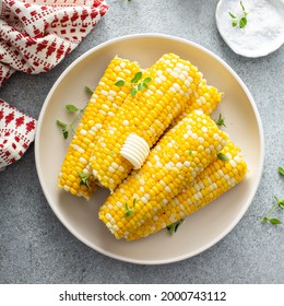 Cooked corn on the cob served with salt and butter, simple summer dish