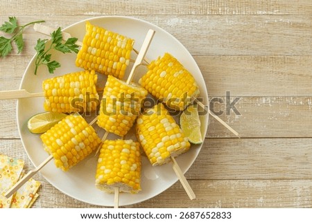 cooked corn on the cob, top view, wooden background, copy space