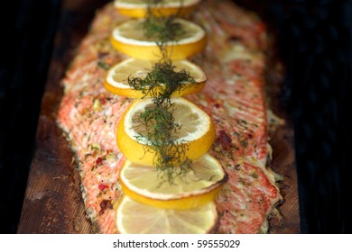 A Cooked Fillet Of Sockeye Salmon With Dill And Lemon On Cedar Plank. Focus On The Lemon And The Dill