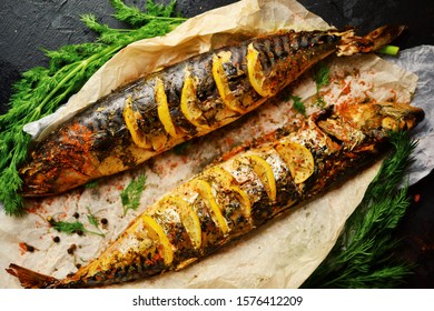 Cooked fish on a dark background. Oven baked mackerel with lemon and dill. - Shutterstock ID 1576412209