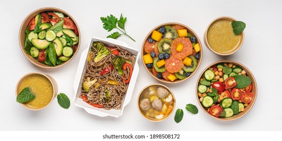 Cooked Food In Paper Eco-friendly Containers On White Background. Food Delivery For Home Or Office. Vegetable, Fruit Salads, Soups, Meat And Side Dishes