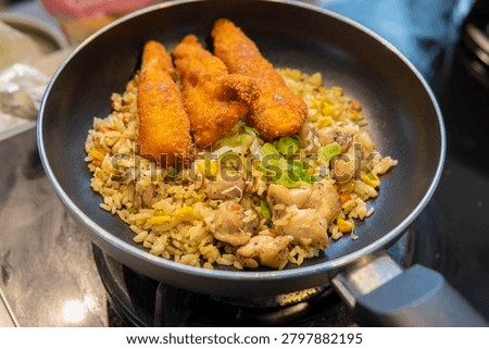 Cooked fried entr�e with vegetable garnish served in black skillet.