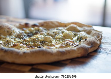 Cooked Garlic Pizza Bread On Wooden Chopping Board