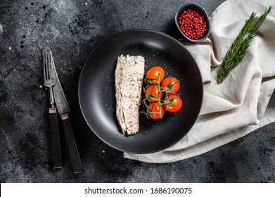 Cooked Haddock Fillet With Cherry Tomatoes. Black Background. Top View