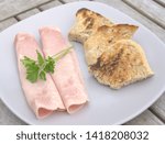 cooked ham and bread on a plate