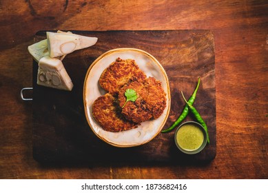 Cooked Jackfruit Kebabs Served In A Traditional Indian Plate With Coriander Sauce. Top Down Flat Lay Of Vegetarian (Kathal) Patty.