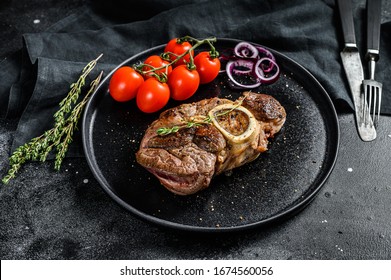 Cooked meat on the bone Osso Buco in tomato sauce. OssoBuco meat stew. Black background. Top view