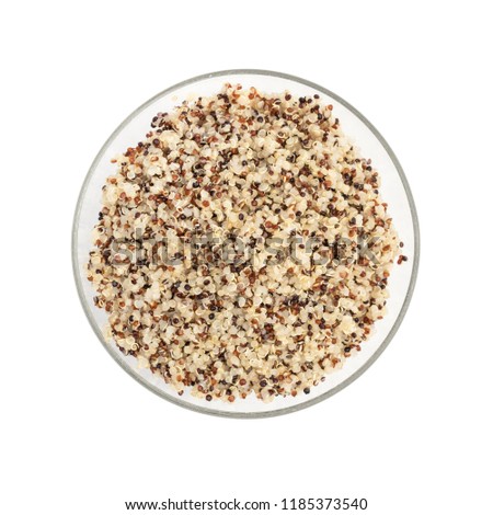 Cooked mixed quinoa seeds in a round glass bowl seen directly from above and isolated on white background