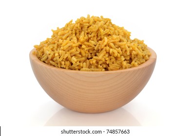 Cooked pilau spiced rice in a beech wood bowl, over white background.