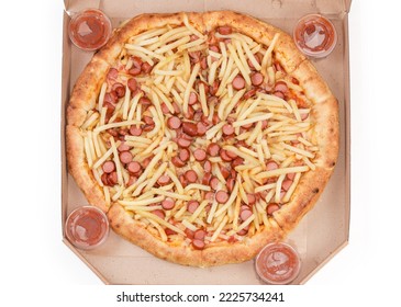 Cooked pizza with French fry and sliced hot dog and condiment in the open cardboard pizza box on a white background, top view - Shutterstock ID 2225734241