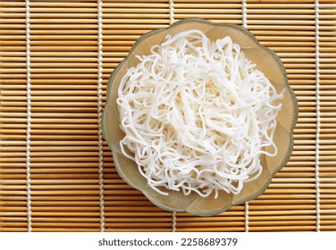 Cooked rice noodles in a bowl, top view - Shutterstock ID 2258689379