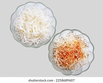 Cooked rice noodles in a bowls, with and without spices. Top view, isolated - Shutterstock ID 2258689607