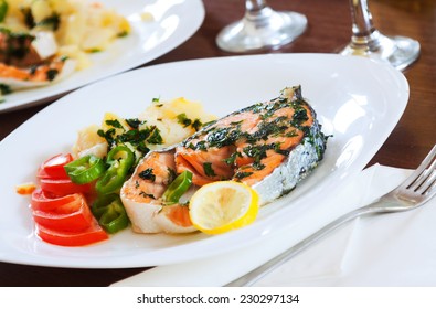 Cooked Salmon Fish On Plate At Table