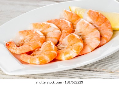 Cooked Shrimp On A White Plate With Lemon