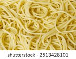 Cooked spaghetti background. Close-up spaghetti texture with concept of abstract, cooking, pasta, ingredients, eating healthy, yellow, and food culture. Food texture background of cooked spaghetti.