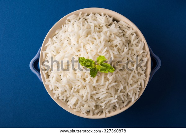 Cooked or steamed Indian Basmati white\
rice in a rustic ceramic bowl, selective\
focus