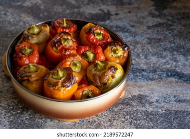 Cooked stuffed peppers minced meat baked in oven, paprika with crust under caps in round baking dish on wooden stand. Stone work kitchen surface. Healthy dish recipe. Meat with vegetables. Copy space. - Shutterstock ID 2189572247