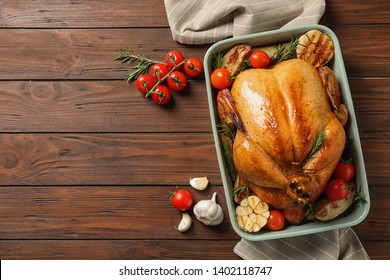 Cooked Turkey With Vegetables And Rosemary In Dish On Wooden Background, Flat Lay. Space For Text