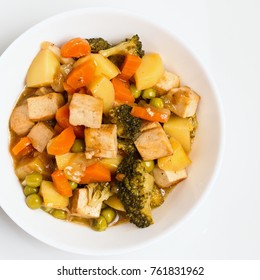 Cooked Vegetables With Tofu In White Bowl. Top Down View On The Dish