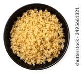 Cooked white quinoa in a black ceramic bowl isolated on white. Top view.