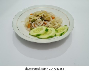 Cooked White Vermicelli Plus Sliced Carrots, Mustard Greens, Topped With Sliced Cucumbers On A White Plate