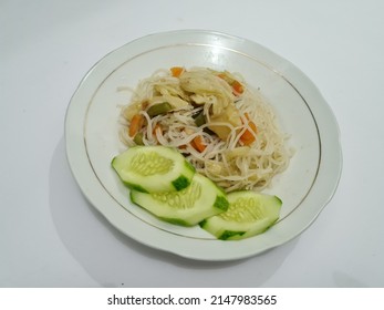 Cooked White Vermicelli Plus Sliced Carrots, Mustard Greens, Topped With Sliced Cucumbers On A White Plate