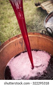 cooked wine preparation: pouring wine in the copper pot