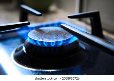 Cooker As Heater. Blue Flame From Gas Hob Produce Greenhouse Gas Emissions. Wastage Of Natural Resources. Kitchen Stove Grate On A Burner Fuelled By Combustible Natural Gas Or Syngas, Propane, Butane.