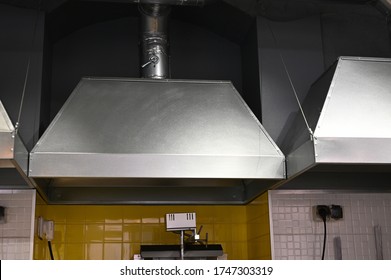 cooker hood over a stove over a stove in a restaurant
