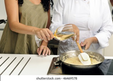 Cookery Course: Pouring Wine Into A Pan With Risotto