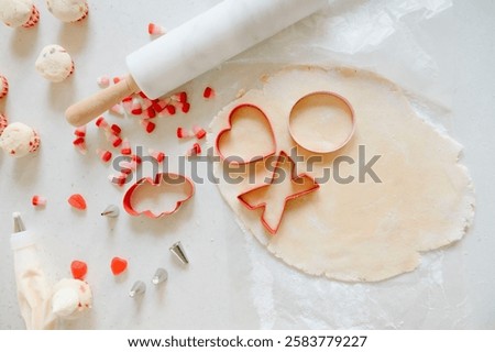 Valentine’s cookie baking with red candy, and cookie cutters