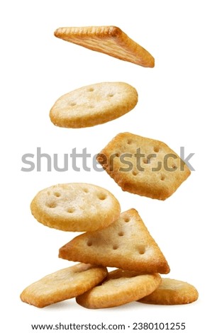 Cookie crackers fall on a pile close-up on a white background. Isolated
