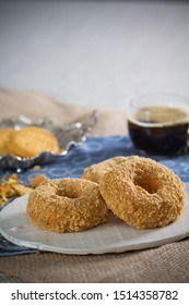 Cookie Crumb Covered Donuts With Coffee In Transparent Mug