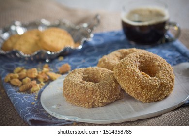 Cookie Crumb Covered Donuts With Coffee In Transparent Mug