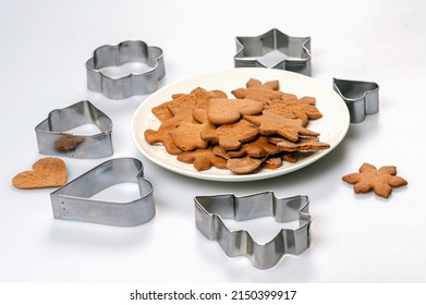 Cookie Cutters And Freshly Baked Gingerbread On A White Plate, Isolated, Copy Space, Close-up