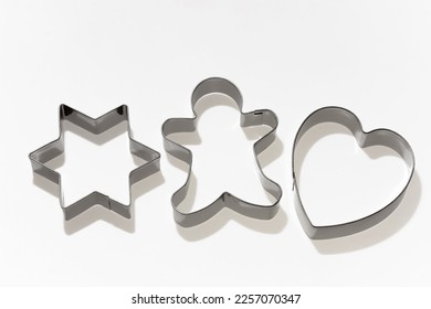 cookie cutters, on white isolate, molds for cutting out figures of a star, a man and a heart from dough - Powered by Shutterstock