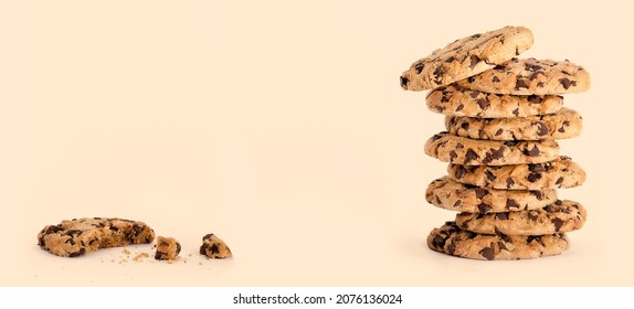 Cookie Day Banner With Delicious Freshly Baked Chocolate Chip Cookies In A Tall Stack, Next To A Partially Eaten One With Crumbs Isolated On Caramel Beige Background With Copy Space For Text