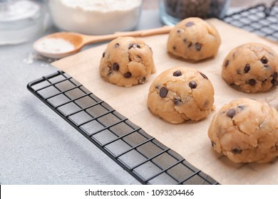 Cookie dough with chocolate chips on cooling rack, closeup - Powered by Shutterstock