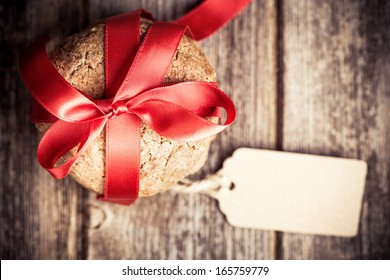 Cookie gift with tag over old wood background, with space for your text. Intentional vignette and shallow depth of field with retro style processing. - Powered by Shutterstock