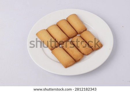 Cookie Plate with Multiple Baked Biscuit Sticks on White Ceramic Plate for Snack and Dessert Concept