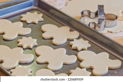 Cookie Sheet With Cut Out Stars And Gingerbread Men