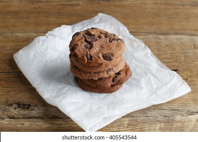 Cookies with chocolate chip on parchment paper napkin on wooden table. - Powered by Shutterstock