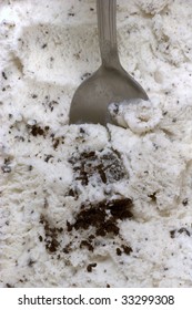 Cookies and Cream flavored ice cream, with a spoon in the middle